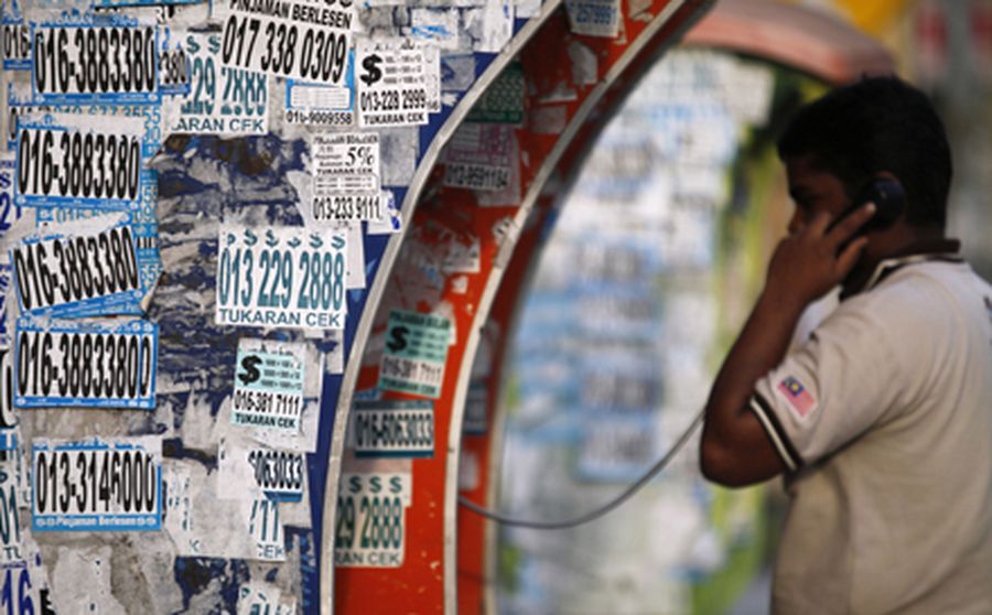 Telephone booths are filled with advertisements offering cash loans on the streets of Kuala Lumpur J